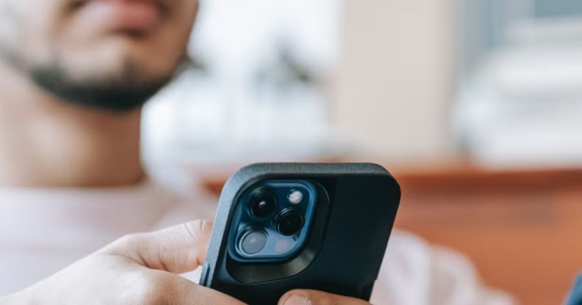 Ein Mann hält ein Smartphone in der Hand, bereit, eine App zu benutzen.