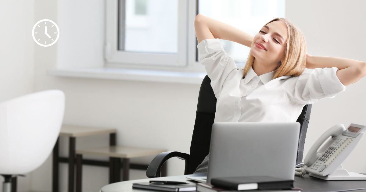 Eine Frau sitzt am Schreibtisch und arbeitet glücklich und entspannt. Oben Links befindet sich eine Uhr welche für flexible Arbeitszeitgestaltung steht